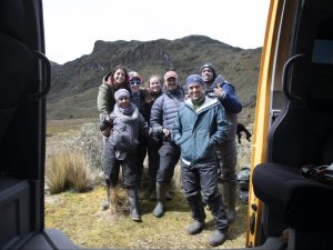 Group shot of Diego Riveros-Iregui and students outside, mountainous terrain in background.