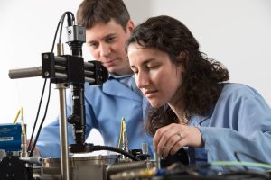 : Taylor S. Teitsworth (with James Cahoon, left) uses a cryogenic probe station, which allows her to perform electrical measurements on semiconductor nanowire materials at very low temperatures.