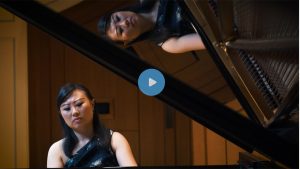 Screen shot of Clara Yang playing the piano.