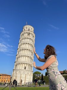 Madi points to the Leaning Tower of Pisa.