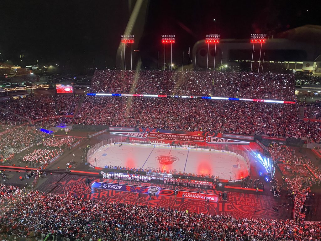 The football stadium near downtown Raleigh was converted into an outdoor hockey rink for the Stadium Series Hurricanes game. Red lights illuminate a sold-out crowd from the view of the press box.
