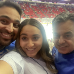 Parisa takes a selfie at the hockey rink with her brother and dad.