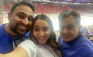 Parisa takes a selfie at the hockey rink with her brother and dad.