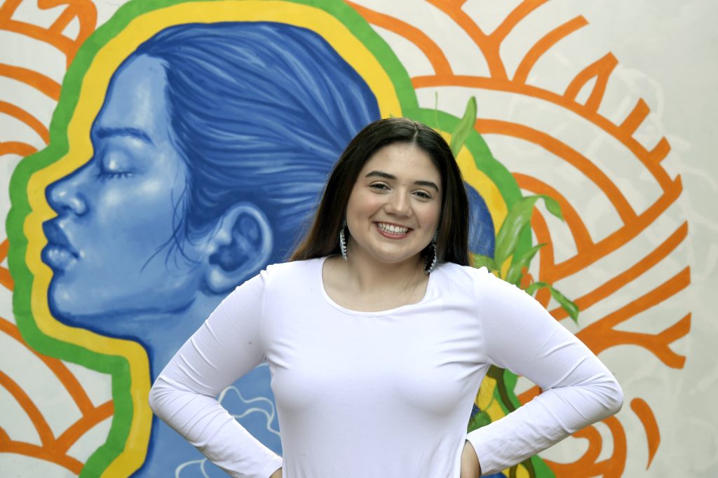 Headshot of Peyton Brooks in front of a colorful mural.
