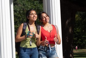 Students give a "thumbs up" at the Old Well on the First Day of Class.
