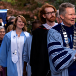 Chancellor Kevin Guskiewicz leads a line of faculty members as they march in the University Day processional outside.