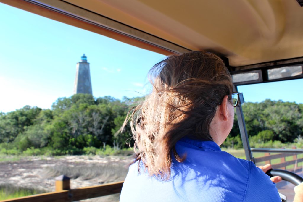 The back of scientist Beth Darrow is seen as she is driving a golf cart.
