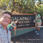 Senay Yitbarek stands in front of a Galapagos sign.