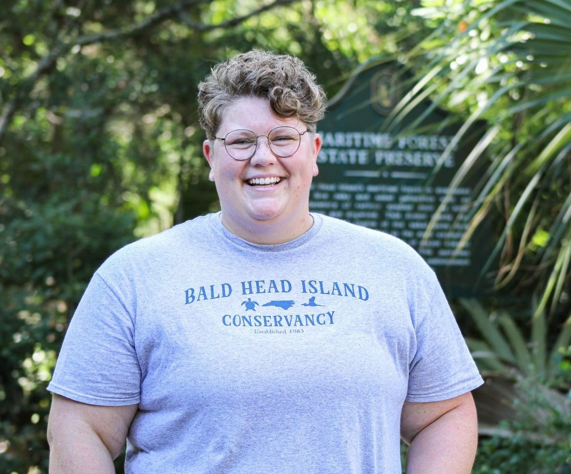Kimmy Hansen stands in front of the maritime forest on Bald Head Island.