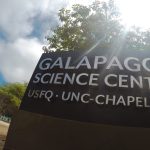 A sign outside the Galapagos Science Center with the center's name, "USFQ," and "UNC-Chapel Hill" written on it.