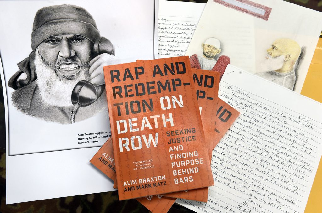 Materials spread on a desk: an illustration of Alim Braxton, the new book Rap and Redemption, and some of Alim's hard copy letters.