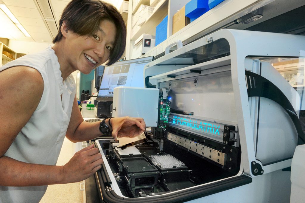 Huong Kratochvil smiles at the camera in her lab.