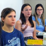 Students listen to their instructor during a College Thriiving course in the classroom.