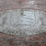 Rain pours down on the University seal on Polk Place on the campus of the University of North Carolina at Chapel Hill on October 11, 2018. (Johnny Andrews/UNC-Chapel Hill)