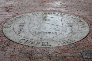 Rain pours down on the University seal on Polk Place on the campus of the University of North Carolina at Chapel Hill on October 11, 2018. (Johnny Andrews/UNC-Chapel Hill)
