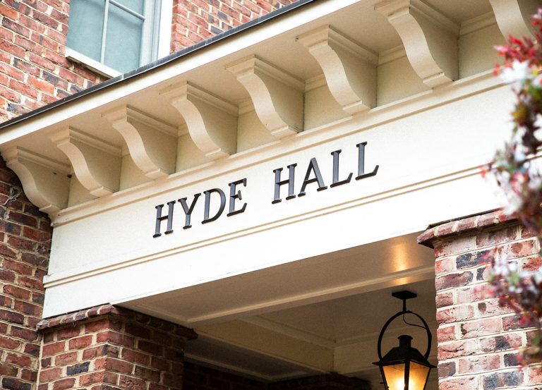 A closeup of the Hyde Hall sign on the front of the building.