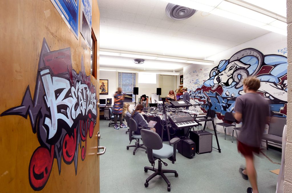 An overview classroom shot of the Beat Lab as a student walks into the room at the Carolina Hip Hop Institute summer 2024.